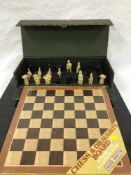 A cast metal chess set, together with a composition chess set, both boxed and two chess boards.