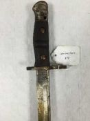 An American sword bayonet, the blade stamped Remington 1917, steel mounted green leather scabbard.