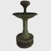 An early twentieth century cast iron garden fountain, two tiers mounted to a circular stone base,