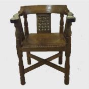 A carved oak armchair by Robert 'Mouseman' Thompson of Kilburn, width 62 cm.