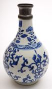A Chinese porcelain blue and white bottle vase: painted with aster and foliate scrolls bisected by