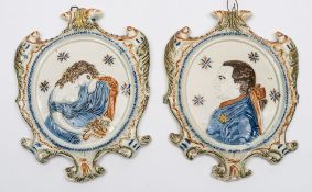 A pair of Staffordshire moulded pearlware wall plaques: of cartouche form painted in Pratt colours,