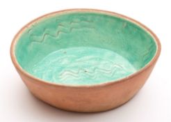 A Fremington pottery baking dish: of oval form,