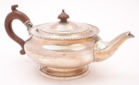 A George V silver teapot, maker William Neale & Son Ltd, Birmingham, 1925: of plain circular form,