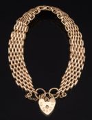 A 9ct gold bracelet: with heart shaped pad-lock clasp and safety chain, 33gms gross weight.