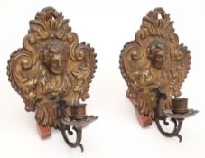 A pair of 19th century embossed brass wall sconces: each of cartouche shaped outline,