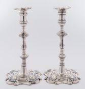 A pair of George II cast silver candlesticks, maker Richard Rugg I, London, 1757: crested,