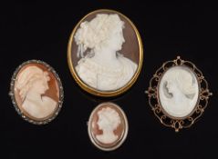 An oval shell cameo portrait brooch depicting a classical woman: her hair adorned with ribbon and
