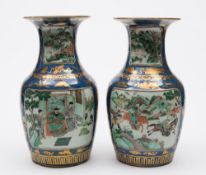 A pair of Chinese famille verte vases: each of baluster form with waisted neck,