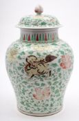A large Chinese wucai baluster vase and cover: painted with three mythical beasts amongst peonies