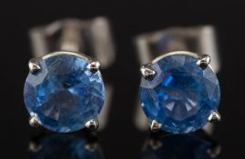 A pair of white metal and circular sapphire single stone screw back ear studs: each circular,