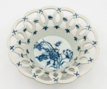 A Worcester blue and white pierced basket: with outswept rim, the exterior applied with florets,