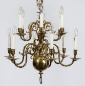 A 19th century Dutch brass two tier twelve branch chandelier: with scrolled arms and outside wiring,