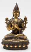 A bronze and gilt bronze Buddha: seated cross legged on a lotus stand in Dharmacakra Mudra pose