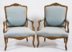 A pair of 19th Century French carved giltwood fauteuils in the Louis XIV taste:,