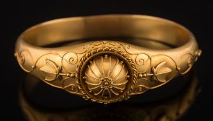 A late 19th century frosted gold hinged bangle: with applied wirework decoration in Etruscan style,