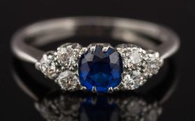 A sapphire and diamond seven stone cluster ring: with central cushion-shaped sapphire 5.