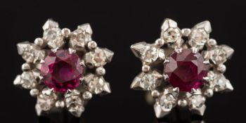 A pair of ruby and diamond circular cluster ear-studs: each with a central round ruby approximately