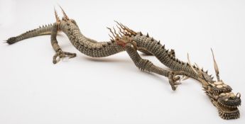 A large Japanese carved and stained ivory articulated dragon: formed from numerous overlapping