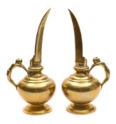 A pair of brass rosewater ewers: of cylindrical form with slender curved V-shaped spouts,