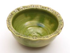 An Edward Sadler (Fremington) pottery bowl: of circular form with everted wavy rim incised on a