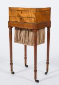 An early 19th Century satinwood and inlaid work table in the Sheraton taste:,