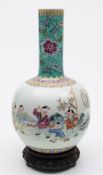 A Chinese porcelain bottle vase: enamelled in the famille rose palette with four children playing
