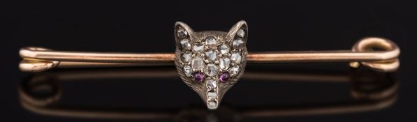 A late 19th century gold, silver and rose diamond mounted fox mask bar brooch:.