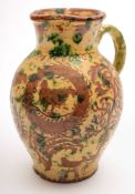 A Donyatt pottery jug: of oviform with raised neck and pinched spout,