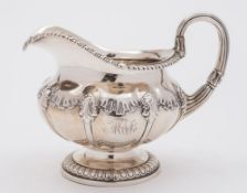 A George IV silver cream jug, maker Paul Storr, London, 1823: crested,
