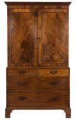 A George III mahogany linen press:, the upper part with a moulded dentil cornice,