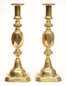 A pair of late 19th century 'Ace of Diamonds' pattern brass candlesticks: with cylindrical nozzles,