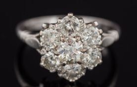 An 18ct white gold and diamond mounted circular cluster ring: with central round old brilliant-cut