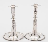 A pair of Swiss silver candlesticks: crested, the plain cylindrical nozzles with knopped stems,