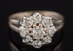 A diamond mounted circular cluster ring: with circular brilliant-cut stones estimated to weigh a