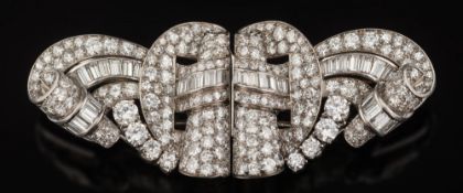 A platinum and diamond double-clip brooch: of openwork scroll design, claw,