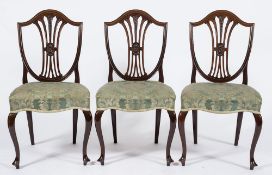 A set of four Edwardian mahogany dining chairs:, in the Hepplewhite taste,