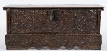 A 17th Century Continental carved oak rectangular coffer:, with a plain hinged top,