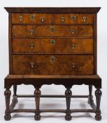 An early 18th Century walnut veneered chest on a later stand:,