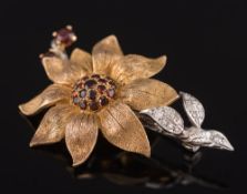 A 9ct gold, garnet and diamond mounted floral spray brooch:, approximately 12gms gross weight.
