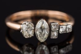 An 18ct gold and diamond six stone ring: with marquise-cut and cushion-shaped diamonds estimated to