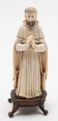 An Indo-Portugese carved and stained ivory figure of a Saint,