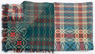 A pair of Welsh bedspreads: with all over geometric designs to a green ground,