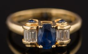 A sapphire and diamond five stone ring: the oval sapphire approximately 7mm long x 5mm wide and