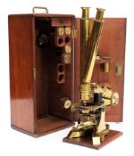 A lacquered brass binocular microscope: with coarse and fine focusing,