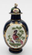 A Worcester tea canister and cover: of plain ovoid form with flower finial,