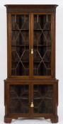 An Edwardian mahogany standing corner display cabinet:, in two parts,
