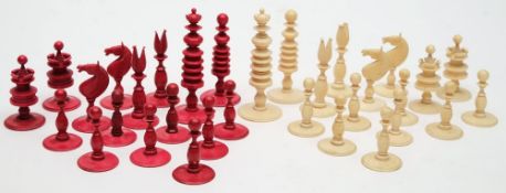 A 19th century ivory chess set of 'barleycorn' type: one side stained red,