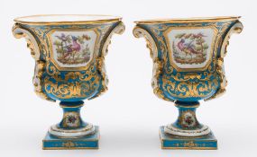 A pair of Sèvres-style porcelain vases: of campana form with mask head scroll handles,