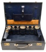 A blue leather travelling vanity case containing continental silver gilt mounted toiletry jars: and